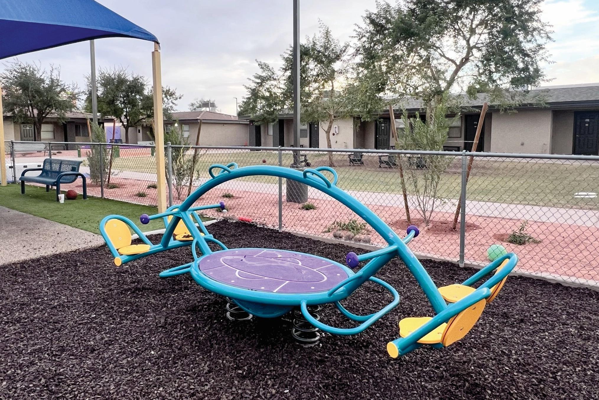 A seesaw to accomodate four young riders sits in a residential community.